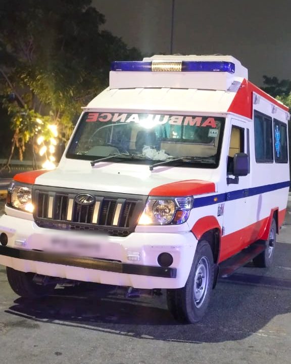 R.N Ambulance Service Mahindra Bolero ambulance at night with its emergency lights on
