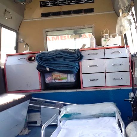 Steel storage drawers, IV stand and stretcher inside an ambulance